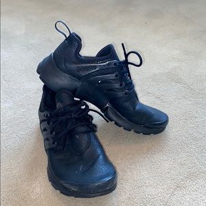 All black leather Nike prestos